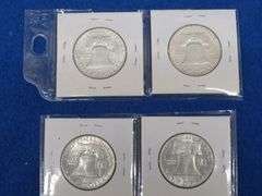 Four Franklin half-dollars