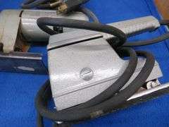 Vintage sabre saw and sander, battery charger, and more