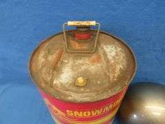 Vintage snowmobile Stancan 6.5 gallon steel gas can and a 6 7/8-7" Bell helmet.