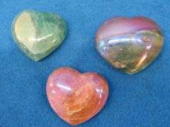 Three heart shapes stones.  Flourite, Aura Quartz, and a Peach Moonstone.  Total weight of 1.11 lb.