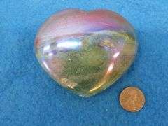 Three heart shapes stones.  Flourite, Aura Quartz, and a Peach Moonstone.  Total weight of 1.11 lb.