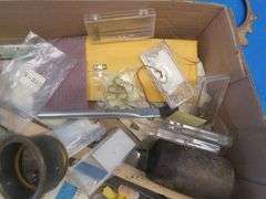 Clock parts including weights, extremely small screws, and more.