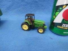 Two toy tractors.  Minneapolis Moline with a trailer and a John Deere.
