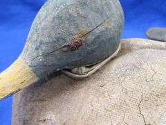 Two vintage duck decoys, one cork and one wooden with glass eyes
