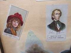 Two scrapbooks filled with postcards, greeting cards. tobacco cards, and more