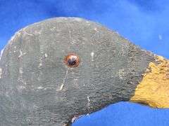 Vintage wooden duck decoy with glass eyes