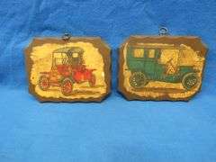 Two wall plaques depicting antique cars