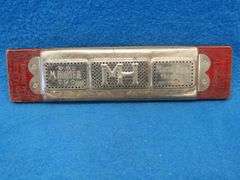 Hohner 40-hole double-sided tremolo harmonica.  Sounds great.