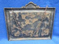 Cast iron plaque showing a horse-drawn fire engine with no markings