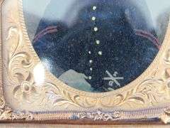 Civil-War-era tintype in a military-themed case.  Very good condition.  Hand-colored photo of a sold