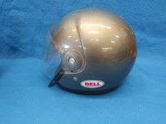 Vintage snowmobile Stancan 6.5 gallon steel gas can and a 6 7/8-7" Bell helmet.