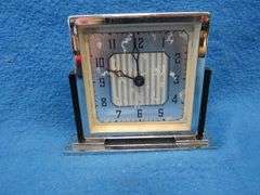 Four clocks for parts or repair.[ The large rectangular clock and the small round brass clock are Lu
