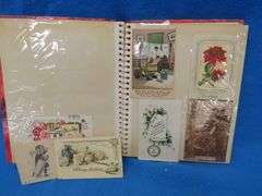Two scrapbooks filled with postcards, greeting cards. tobacco cards, and more