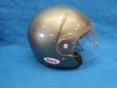 Vintage snowmobile Stancan 6.5 gallon steel gas can and a 6 7/8-7" Bell helmet.