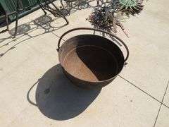 Vintage cast iron kettle 20" wide x 10 1/2" deep, has all three feet and the handle