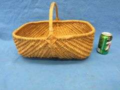 Two wicker baskets, a glass shade, and glass ball fishing floats.