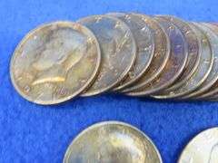 30 clad Kennedy halves and three Eisenhower dollars