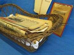 Antique wicker basket with an old Gluek's advertising fan, and Collector's Weekly and Antique monthl
