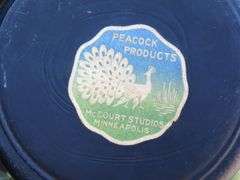 Box lot including a Peacocks Products vase from McCourt Studios in Minneapolis, tote and more