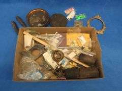 Clock parts including weights, extremely small screws, and more.