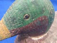 Vintage wooden duck decoy with glass eyes
