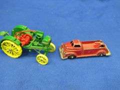Small-scale die-cast John Deere Waterloo Boy tractor and an old metal tow truck