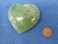 Three heart shapes stones.  Flourite, Aura Quartz, and a Peach Moonstone.  Total weight of 1.11 lb.