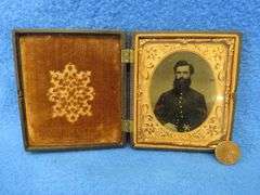 Civil-War-era tintype in a military-themed case.  Very good condition.  Hand-colored photo of a sold