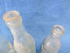 Four old beer bottles from Jac. Schmidt, Gluek, C. Birkhofer, and Jacob Ries