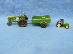 Two toy tractors.  Minneapolis Moline with a trailer and a John Deere.