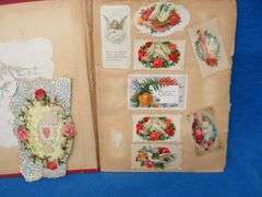 Two scrapbooks filled with postcards, greeting cards. tobacco cards, and more