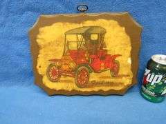 Two wall plaques depicting antique cars