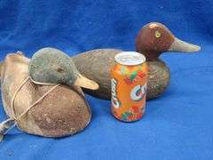 Two vintage duck decoys, one cork and one wooden with glass eyes