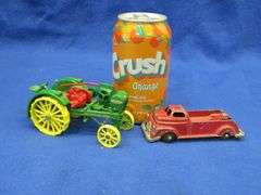 Small-scale die-cast John Deere Waterloo Boy tractor and an old metal tow truck