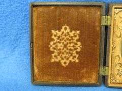 Civil-War-era tintype in a military-themed case.  Very good condition.  Hand-colored photo of a sold