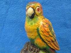 Lux wood and plaster painted parrot clock.  Movement works but hands don't move.