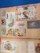 Two scrapbooks filled with postcards, greeting cards. tobacco cards, and more