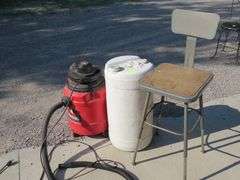 Genie 1.5-gallon shop vacuum, plastic container, and a shop stool