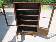 Two door free standing bookcase with beveled glass and lower storage area.  56" x 36" x 11"