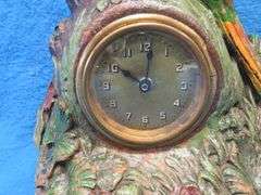 Lux wood and plaster painted parrot clock.  Movement works but hands don't move.
