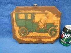 Two wall plaques depicting antique cars