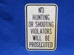 Plastic like No Hunting or Shooting sign that has been hunted