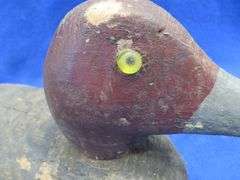 Two vintage duck decoys, one cork and one wooden with glass eyes