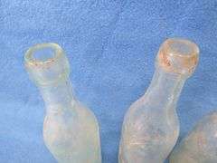 Four old beer bottles from Jac. Schmidt, Gluek, C. Birkhofer, and Jacob Ries