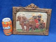 Cast iron plaque showing a horse-drawn fire engine with no markings
