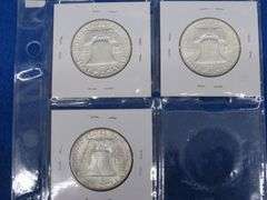 Three Franklin half-dollars