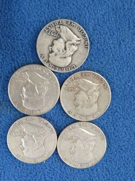 Five Benjamin Franklin silver half-dollars