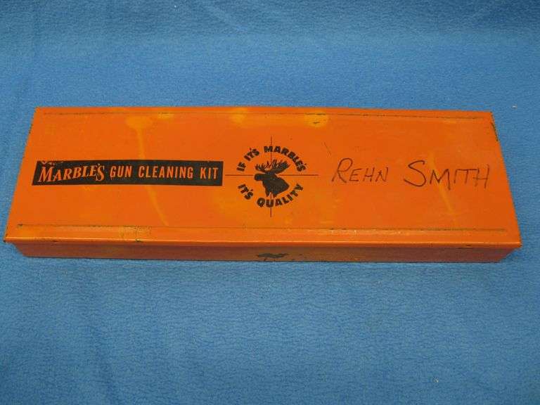 A metal Marble's gun cleaning box with contents