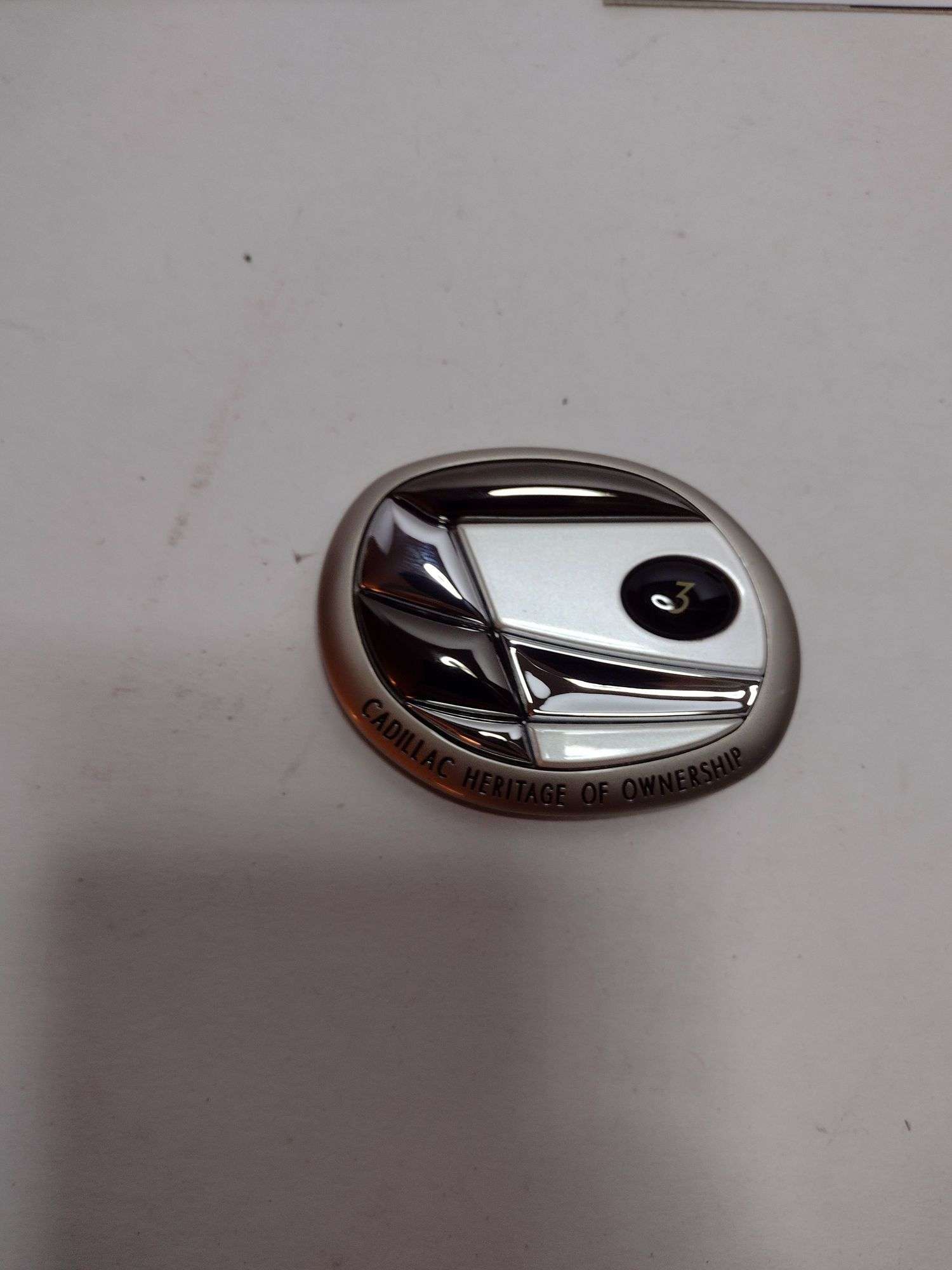 The heritage of ownership medallion from capital Cadillac - Lil 