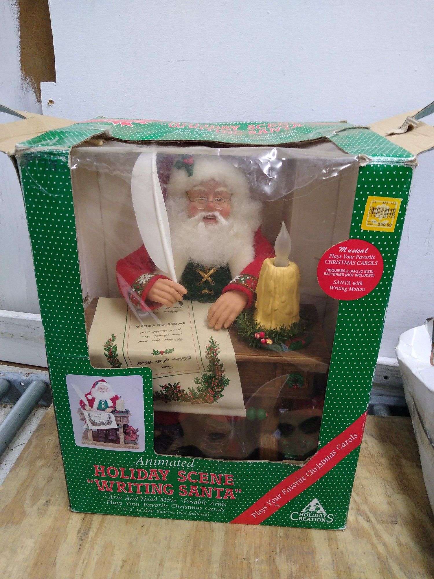 Animated holiday scene writing Santa plays Christmas carols in box 